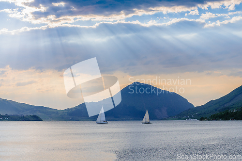 Image of sailboats on calm sea and clouds