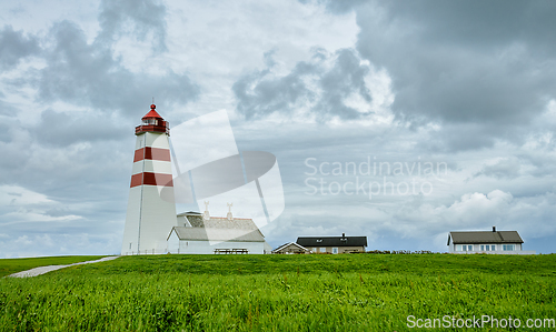 Image of lighthouse on the coast with clouds