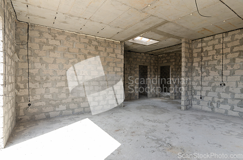Image of Construction of an individual residential building, a large spacious room with a concrete floor and reinforced concrete ceilings