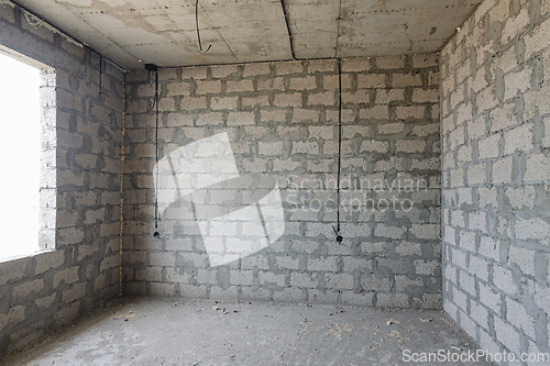 Image of Construction of an individual residential building, a view of the expanded clay concrete wall without finishing, electric wires are laid