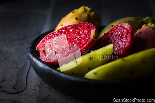 Image of Prickly pear in black bowl on black background