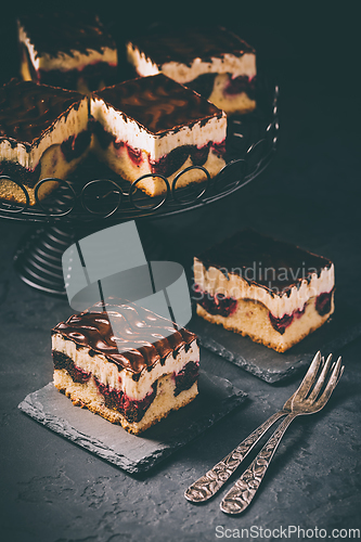 Image of German cake Donauwelle (Danube waves) - vanilla and chocolate sponge cake with sour cherries, vanilla buttercream and chocolate icing 