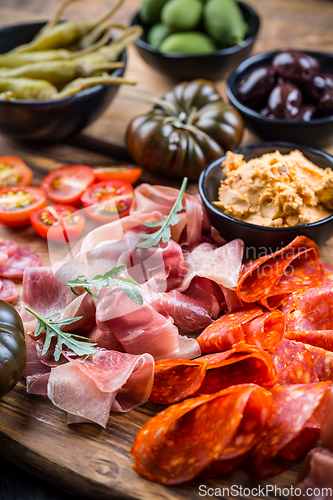 Image of Charcuterie board with prosciutto ham, salami, olives and tapas