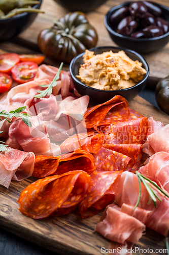 Image of Charcuterie board with prosciutto ham, salami, olives and tapas