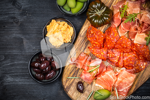 Image of Charcuterie board with prosciutto ham, salami, olives and tapas