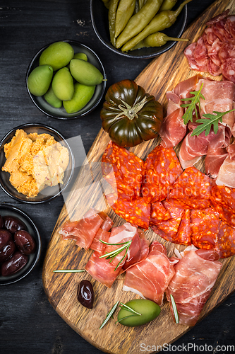 Image of Charcuterie board with prosciutto ham, salami, olives and tapas