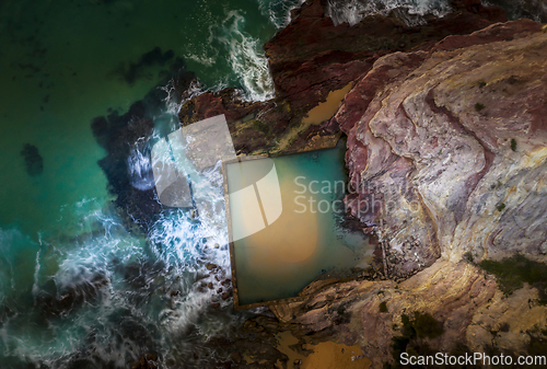 Image of Waves overflow into an ocean rockpool