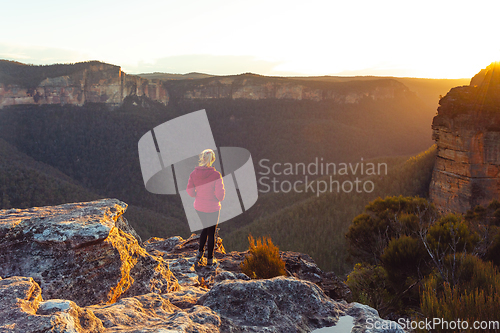 Image of Sunlight streaming into valley and onto a cliff ledge hiker stan