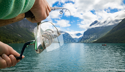 Image of Woman fishing on Fishing rod spinning in Norway.