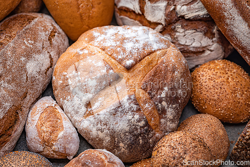 Image of Freshly baked natural bread is on the kitchen table.