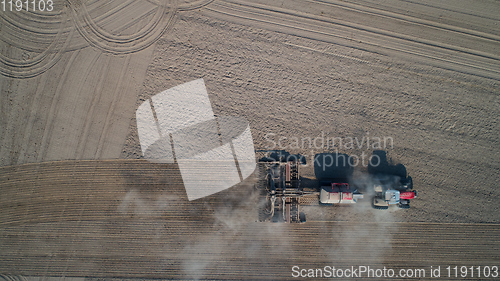 Image of Farmer in tractor preparing land with seedbed cultivator, top view