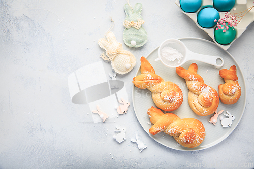 Image of Easter baking - Buns made from yeast dough in a shape of Easter bunny and colored eggs