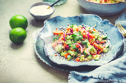 Image of Healthy quinoa black bean salad with fresh tomatoes, cucumbers, onion and cilantro