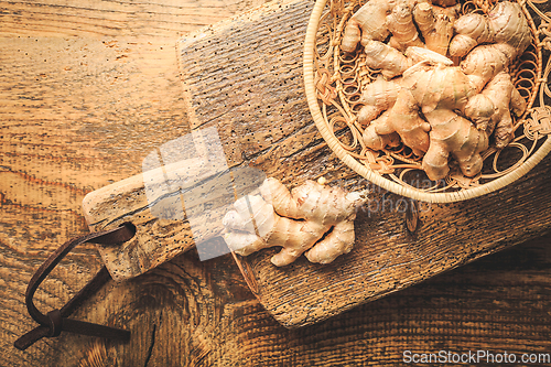 Image of Fresh organic ginger roots on wooden background