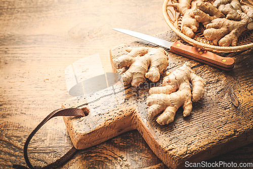 Image of Fresh organic ginger roots on wooden background