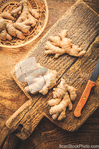 Image of Fresh organic ginger roots on wooden background