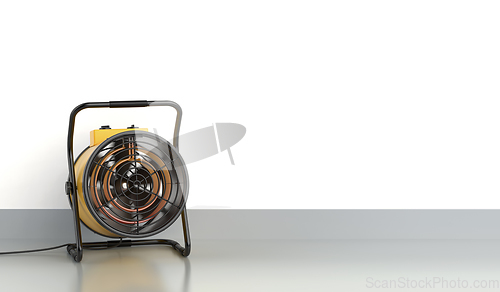 Image of Yellow cylinder shaped electric fan heater