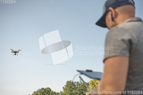 Image of Man manages quadrocopters. Remote control for the drone in the hands of men. Unmanned aerial vehicle