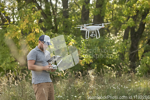 Image of Man manages quadrocopters. Remote control for the drone in the hands of men. Unmanned aerial vehicle