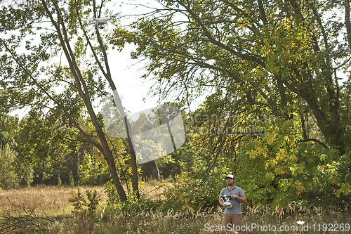 Image of Man manages quadrocopters. Remote control for the drone in the hands of men. Unmanned aerial vehicle