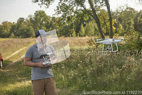 Image of Man manages quadrocopters. Remote control for the drone in the hands of men. Unmanned aerial vehicle