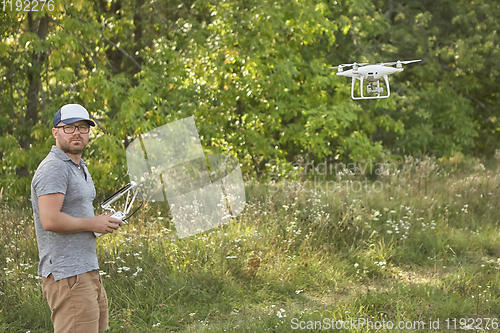 Image of Man manages quadrocopters. Remote control for the drone in the hands of men. Unmanned aerial vehicle