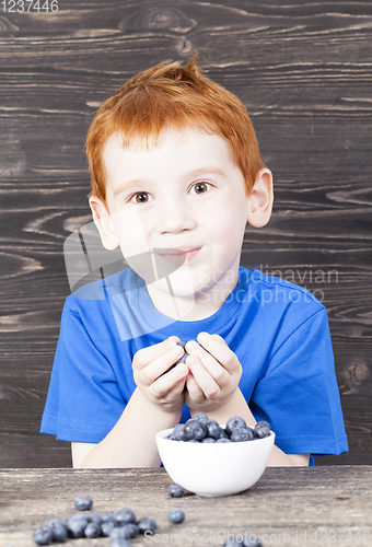 Image of boy and blueberry