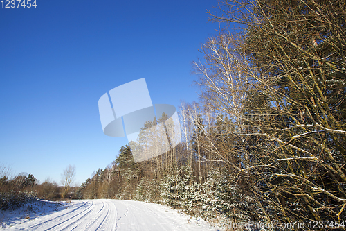 Image of rural road covered with snow closeup