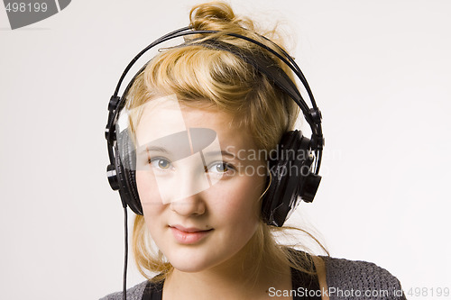 Image of Young woman listening to music