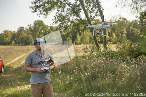 Image of Man manages quadrocopters. Remote control for the drone in the hands of men. Unmanned aerial vehicle