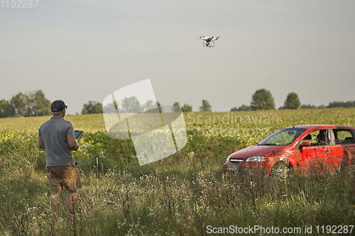 Image of Man manages quadrocopters. Remote control for the drone in the hands of men. Unmanned aerial vehicle