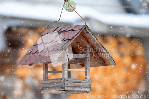 Image of Wooden Bird Feeder in snowy day