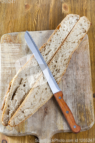 Image of knife cutting cut dish bread