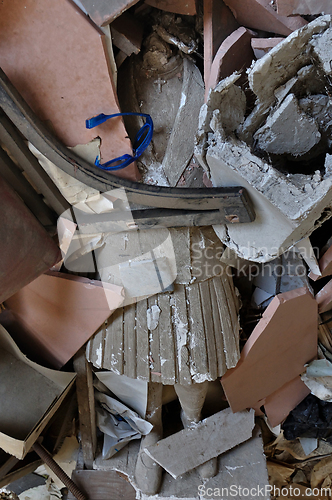 Image of headless statue among debris