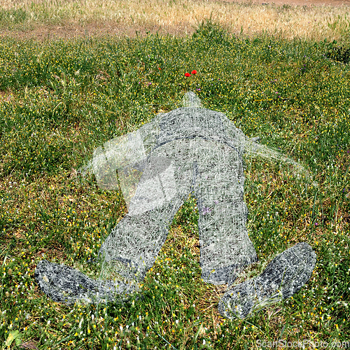 Image of human figure imprinted on grass