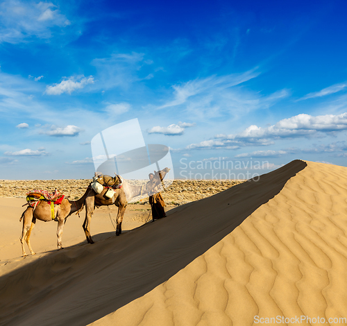 Image of Cameleer (camel driver) with camels in dunes of Thar desert. Raj