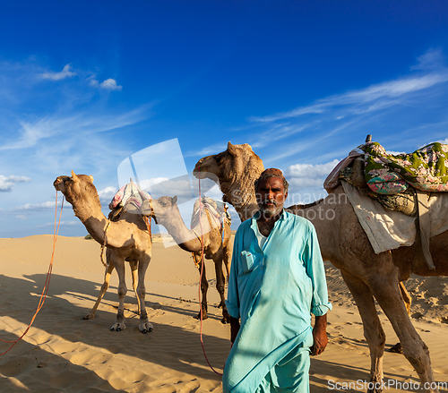 Image of Cameleer (camel driver) with camels in dunes of Thar desert. Raj