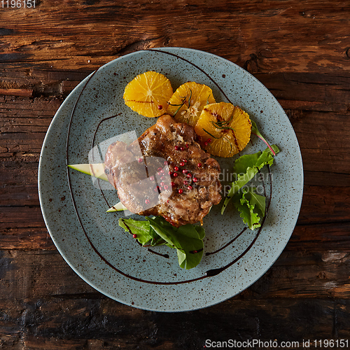 Image of Chicken Steak with oranges and greens. Shallow dof.