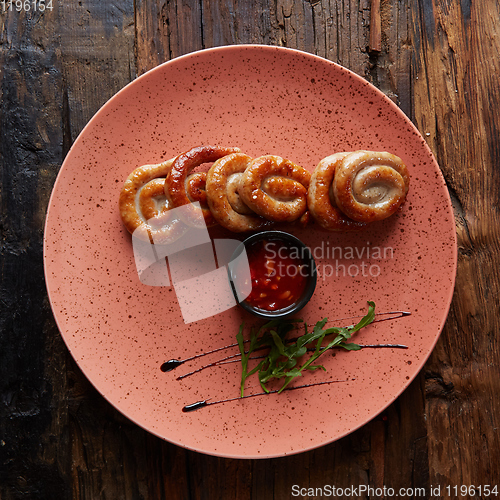 Image of The grilled sausages in plate. Top view.