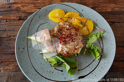 Image of Chicken Steak with oranges and greens. Shallow dof.