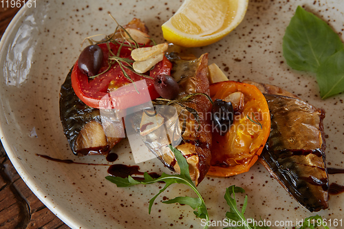 Image of The fried mackerel with vegetables. Shallow dof.