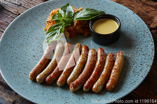 Image of The grilled sausages in plate. Top view.