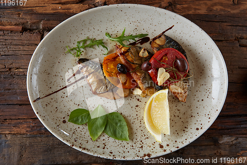 Image of The fried mackerel with vegetables. Shallow dof.