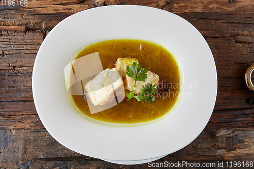 Image of Onion soup in the ceramic pot. Shallow dof.