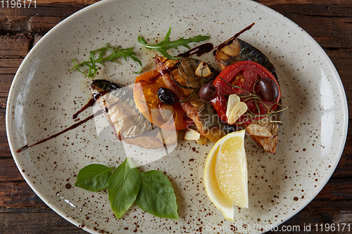 Image of The fried mackerel with vegetables. Shallow dof.