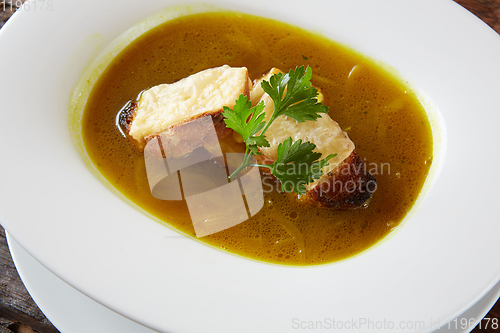 Image of Onion soup in the ceramic pot. Shallow dof.