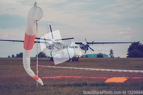 Image of parachutist aircraft on land