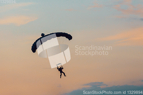 Image of parachuting sport in sunset sky