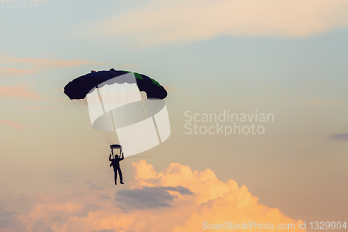 Image of parachuting sport in sunset sky