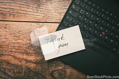 Image of Closeup of Thank You sticky note message on laptop